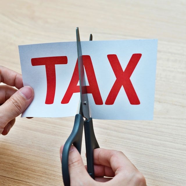 scissors cutting the word tax