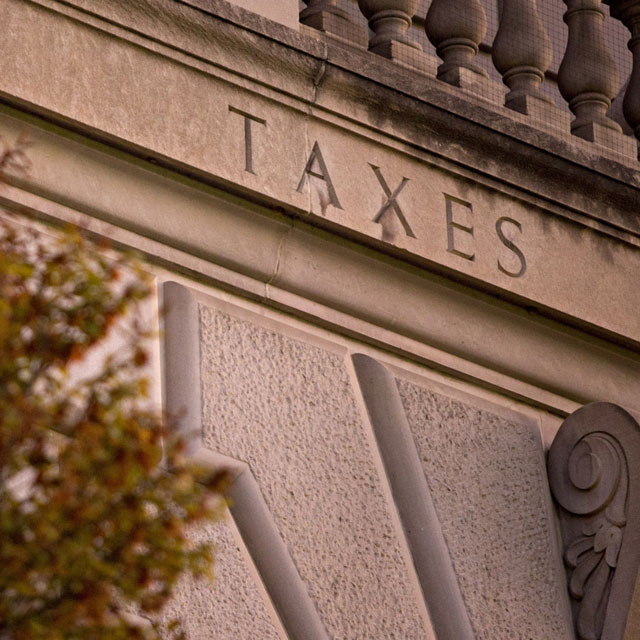 The word 'Taxes' is seen on the facade of the IRS headquarters in Washington